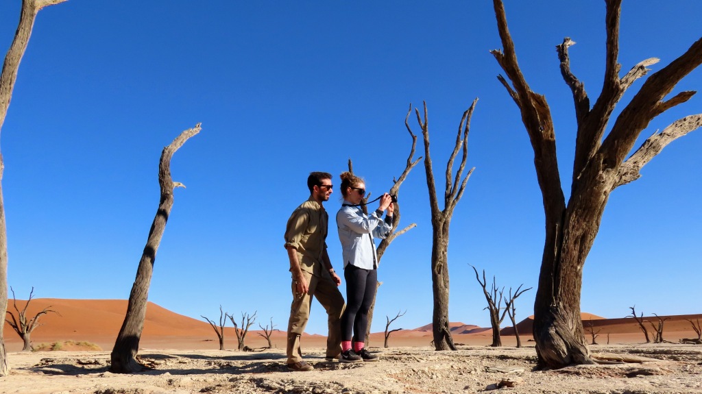 A couple taking photos at Deadvlei Namibia