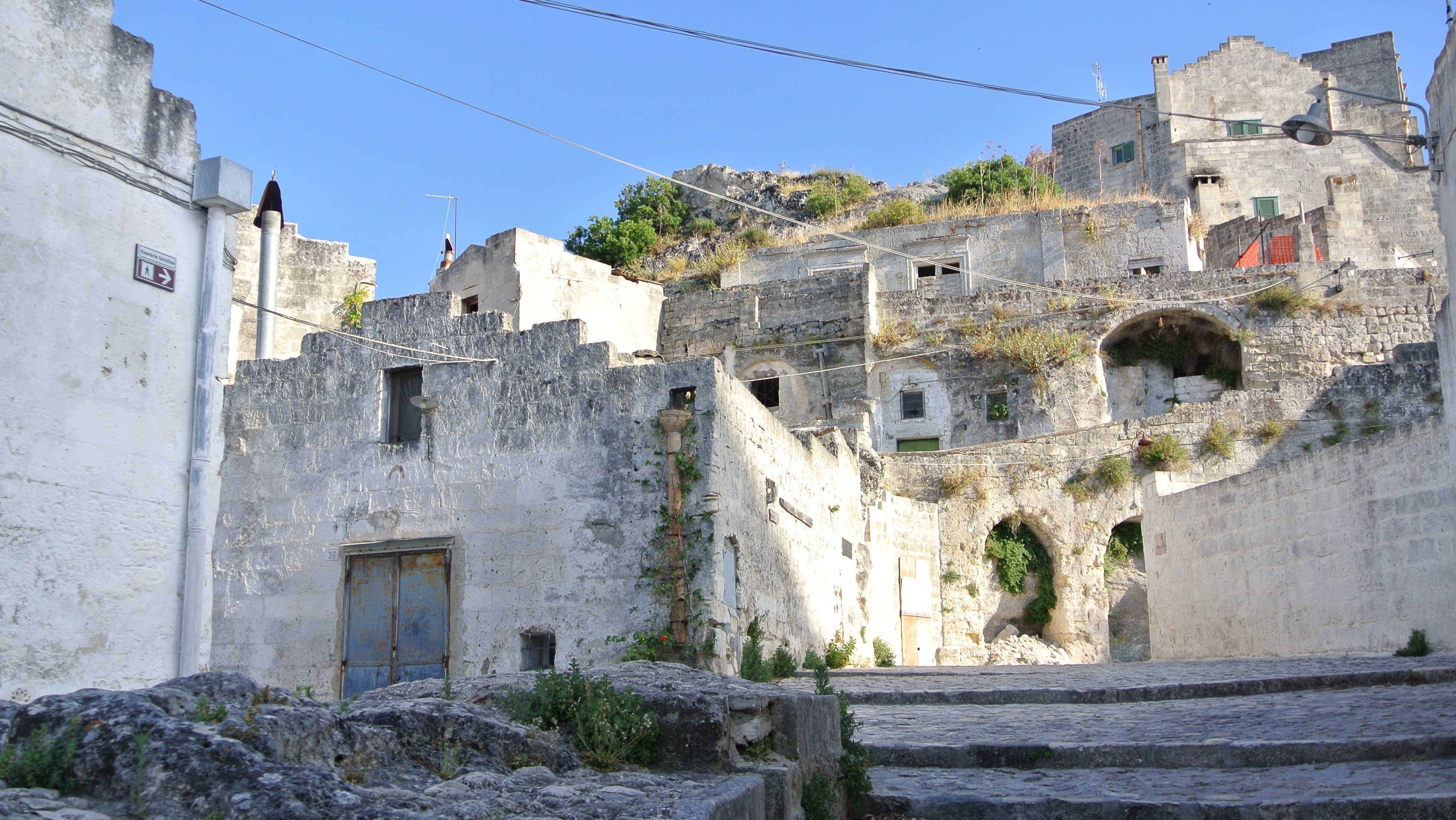 A street with houses cut into rock in Matera, Italy